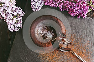 Classic chocolate fondant on a dark background with flowers