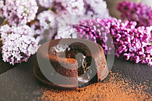 Classic chocolate fondant on a dark background with flowers