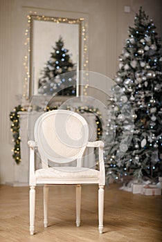 Classic Christmas decorated interior room New year tree. Christmas tree with gold decorations. Modern white classical style