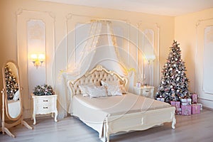 Classic Christmas decorated interior room with New year tree. Modern luxury design apartment bedroom with bed. Christmas