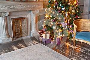 Classic christmas New Year decorated interior room fireplace New year tree. Christmas tree with gold ornament decorations. Modern