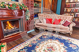 Classic Christmas New Year decorated interior room home library with fireplace. Christmas tree with red ornament decorations.