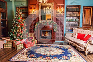 Classic Christmas New Year decorated interior room home library with fireplace. Christmas tree with red ornament decorations.