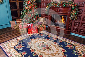 Classic Christmas New Year decorated interior room home library with fireplace. Christmas tree with red ornament decorations.