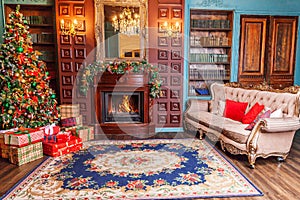 Classic Christmas New Year decorated interior room home library with fireplace. Christmas tree with red ornament decorations.