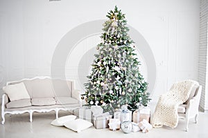 Classic christmas New Year decorated interior room New year tree. Christmas tree with gold decorations. Modern white classical sty