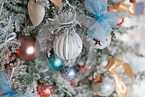 Classic Christmas New Year decorated New year tree with silver and white ornament decorations toy and ball. Modern classical style