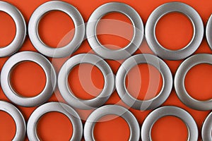 Classic chrome eyelets for curtains on an orange background