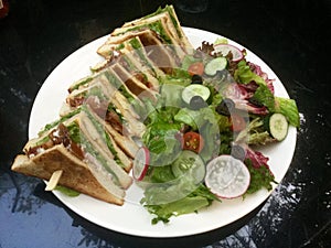 Classic Club Sandwich . fresh green salad . Delicious