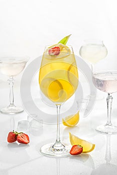 Classic cocktail in glass on white background with lime, mandarins, soda, alcohol and lemon