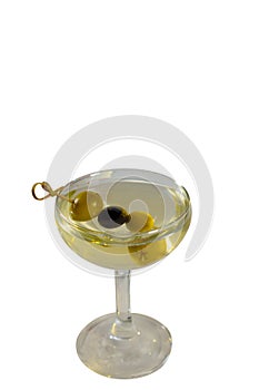 Classic cocktail Martini with vodka and olives poured in a glass