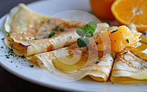 Classic crepes Suzette with a zesty orange butter saucer on plate, closeup