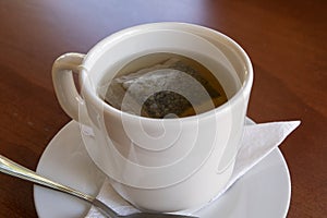 Classic cup of tea served in white cup at restaurant