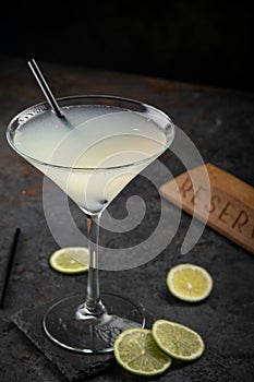 Classic Daiquiri cocktail of rum and lime juice on a dark stone