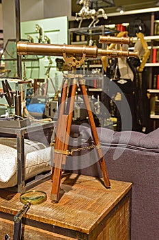 Classic design telescope with wooden leg support in a shop selling vintage goods