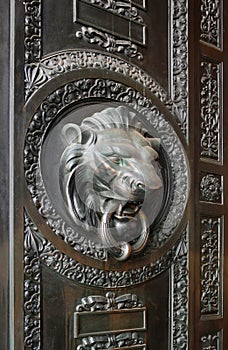 A classic door knocker in the shape of a lion.