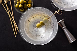 Classic Dry Martini with olives on black background.