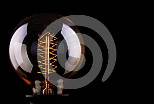 Classic Edison light bulb on black background