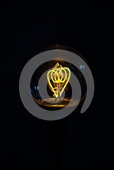 Illuminated light bulb on black background