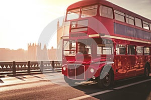 Classic English Red Bus on the Westminster Bridge and Big Ben Tower in the background