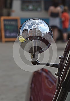 A classic Ford Consul car spotlight with a yellow hotrod reflection photo