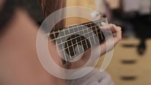 Classic girl playing the guitar. musician acoustic instrument concept. guitarist girl hands close-up playing near