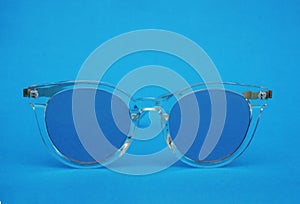 Classic glasses with blue glasses on a blue background.