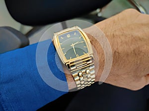 Classic golden watch on hand.