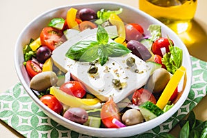 Classic Greek salad of fresh cucumber, tomato, sweet pepper, lettuce, red onion, feta cheese and olives with olive oil