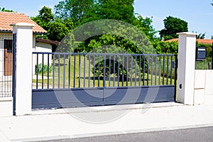 Classic grey door metal home gate at entrance of house garden