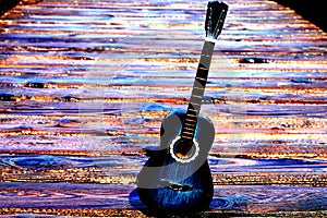 A classic guitar on an imaginatively colored wooden background