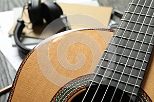 Classic guitar and music maker accessories against wooden background photo