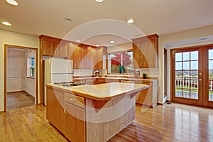 Classic hardwood kitchen with connected living room.