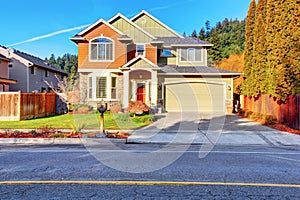 Classic house with garage, driveway, and grassy front yard.