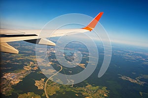 Classic image through aircraft window onto wing. Flight view over Russia