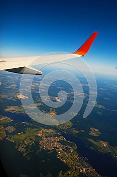 Classic image through aircraft window onto wing. Flight view over Russia