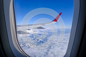Classic image through aircraft window onto wing. Flight view over Turkey
