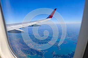 Classic image through aircraft window onto wing. Flight view over Turkey