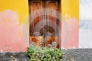 Classic Italian doors on walls painted pink and orange