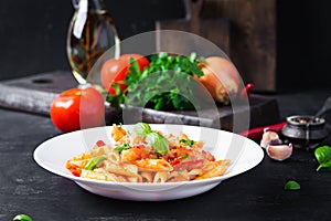 Classic italian pasta penne alla arrabiata with basil and freshly grated parmesan cheese