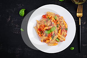 Classic italian pasta penne alla arrabiata with basil and freshly grated parmesan cheese