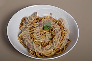 Classic italian spaghetti pasta with tomato sauce, cheese parmesan and basil on the wooden table. View from above, horizontal