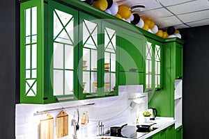 Classic kitchen interior with green trim. Kitchen acrylic countertop with built-in sink