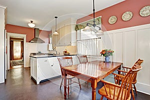 Classic kitchen room with white cabinets, granite counter top and hardwood floor.