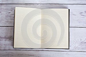 Classic Leather Bound Journal Book Open on a White Barn Board Floor