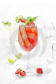 Classic lemonade mix in glass on white background with cucumber, mint, lime and strawberry