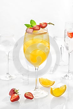 Classic lemonade mix in glass on white background with passion fruit puree, melon, soda, orange