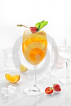 Classic lemonade mix in glass on white background with Sea buckthorn puree, cherry plums, soda and orange