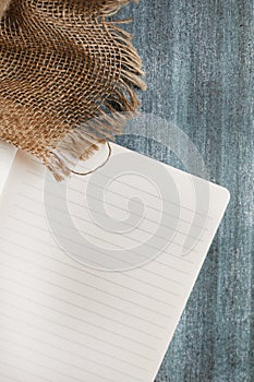 Classic lined notebook and pen in a natural rustic table setting with soft selected focus