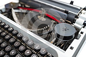 Classic, manual typewriter in white with a German keyboard layout, isolated on a white background with a clipping path.